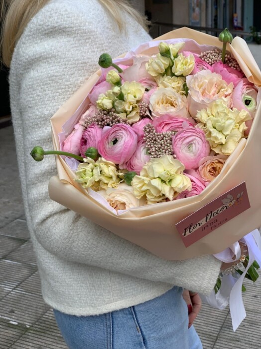 Bouquet with ranunculus, garden roses and matthiola in pastel yellow-pink shades