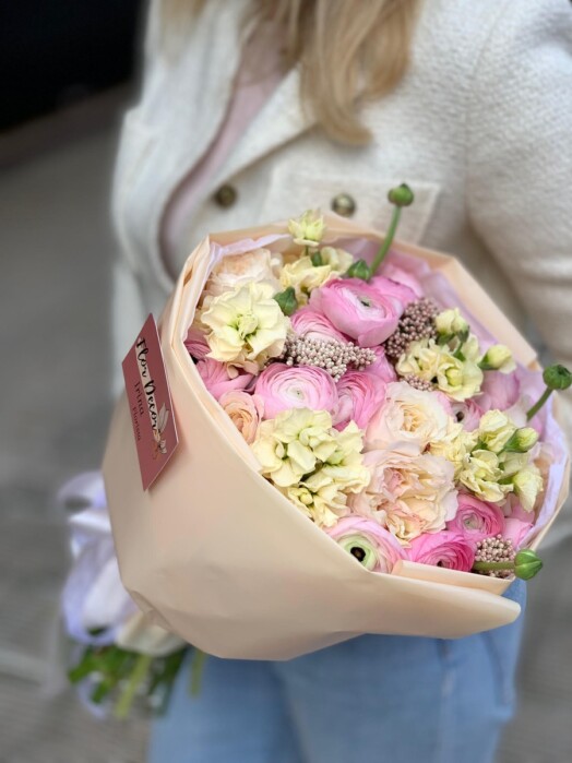 Bouquet with ranunculus, garden roses and matthiola in pastel yellow-pink shades